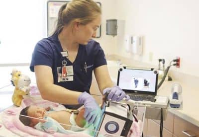 Nurse using Certascan baby footprint scanner